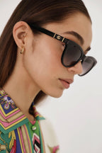 Soft cat-eye femenine black sunglasses – the interlocking logo on temples framed by two gold-coloured bars – LUX VERSE Luxury Designer Fashion Outlet