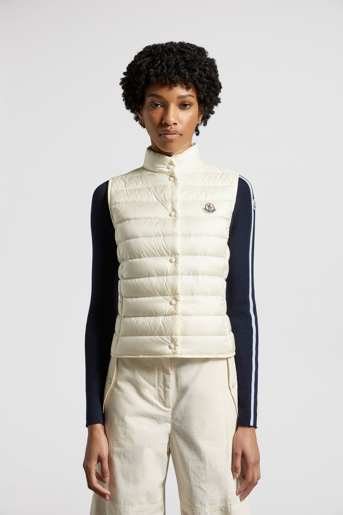 Liane Down Vest – it is characterized by a high neck and a subtle logo patch on the chest – LUX VERSE Luxury Designer Fashion Outlet