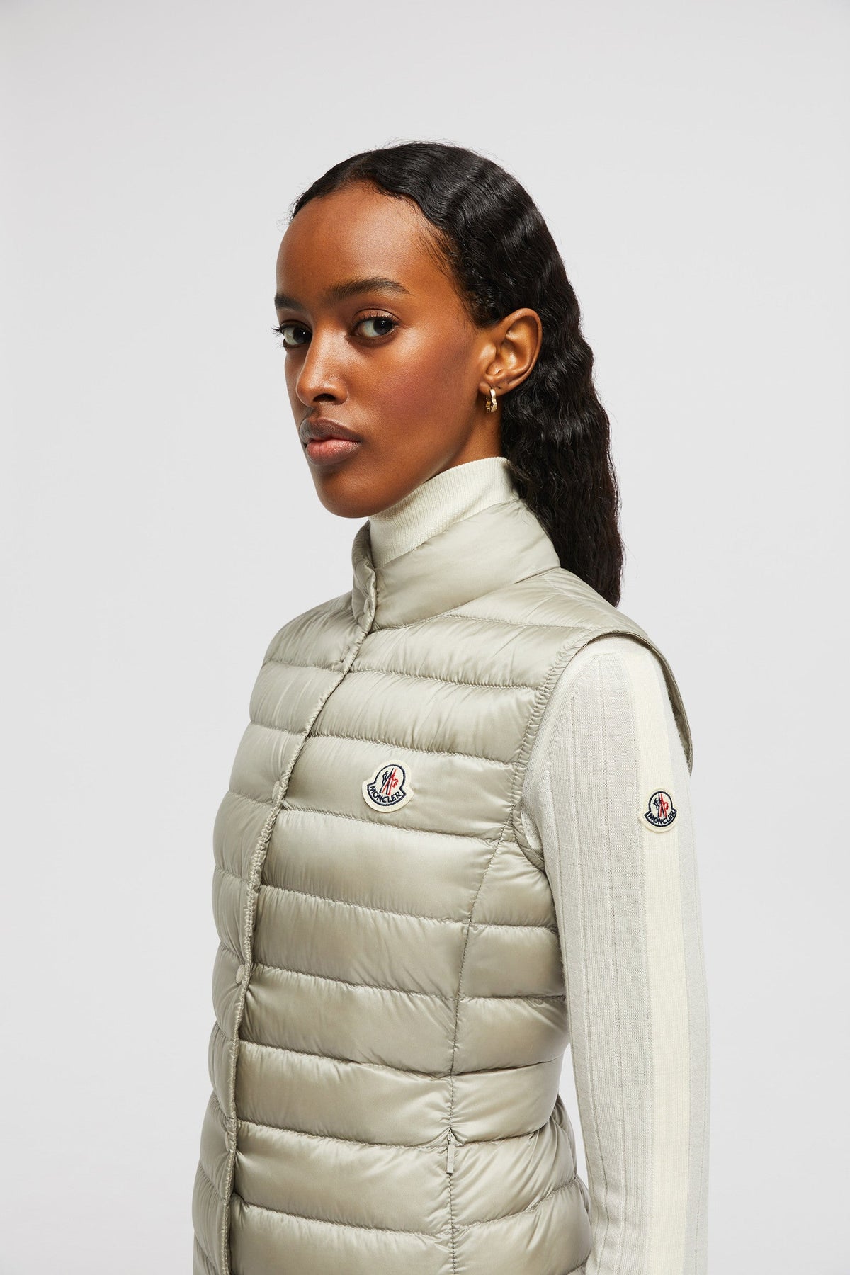Liane Vest – it is characterized by a high neck and a subtle logo patch on the chest – LUX VERSE Luxury Designer Fashion Outlet