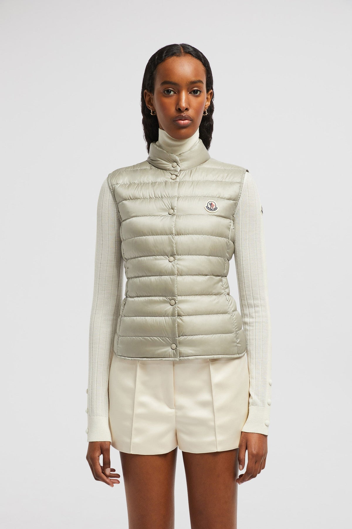 Liane Vest – it is characterized by a high neck and a subtle logo patch on the chest – LUX VERSE Luxury Designer Fashion Outlet