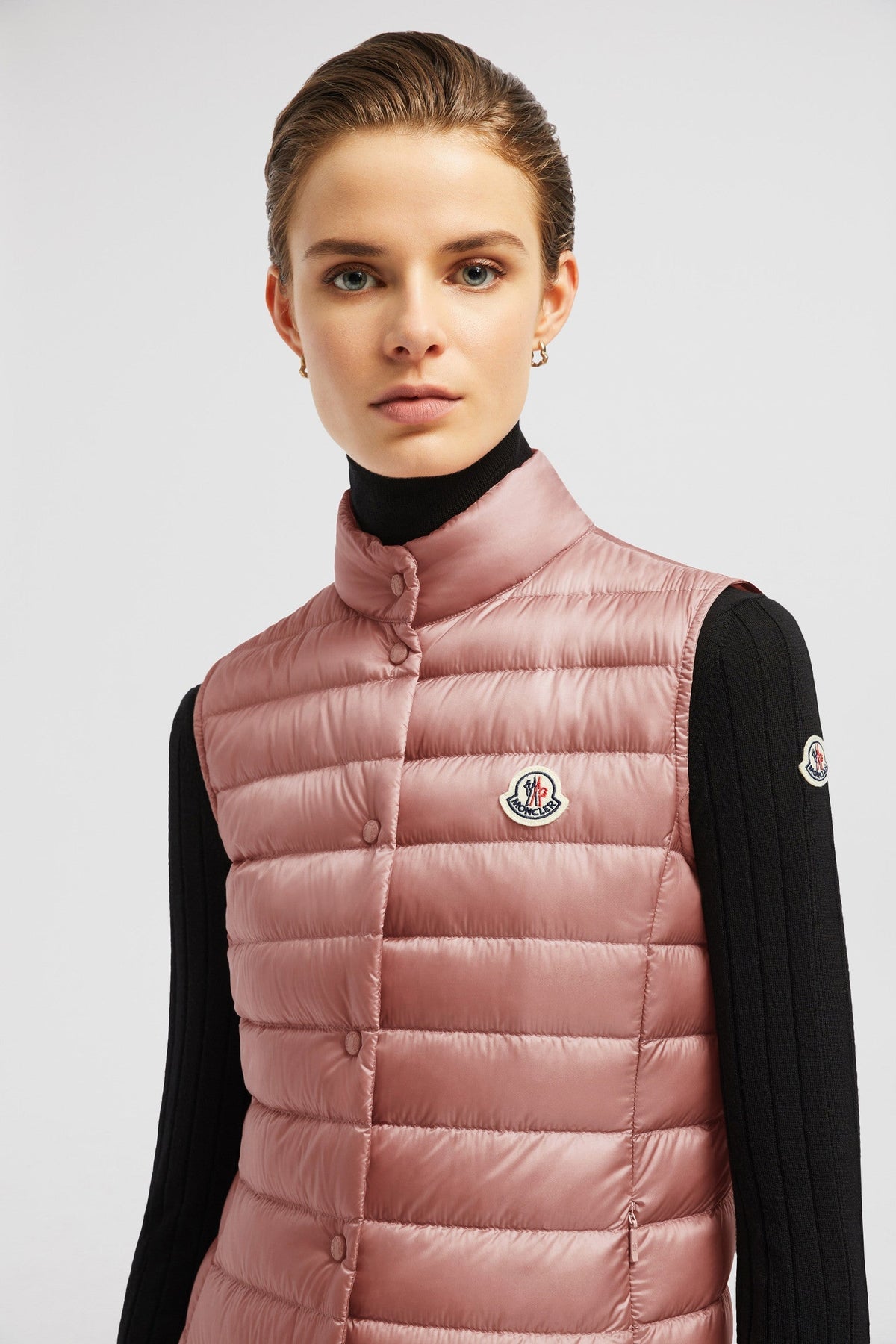 Liane Vest – it is characterized by a high neck and a subtle logo patch on the chest – LUX VERSE Luxury Designer Fashion Outlet