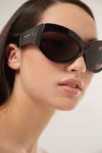 Bold black wrap around sunglasses – the style is enriched by the ionic logo and laser engraved on both – LUX VERSE Luxury Designer Fashion Outlet